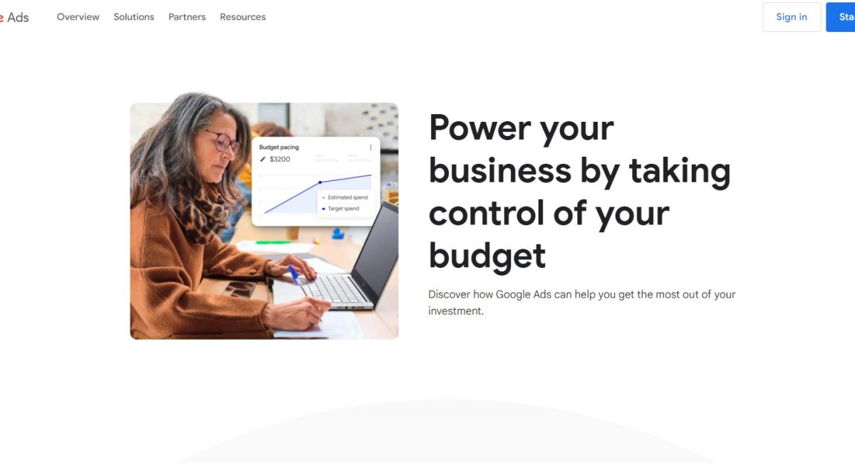 Woman analyzing Google Ads budget on laptop, displaying budget pacing graph with estimated and target spend, emphasizing cost management in digital marketing.