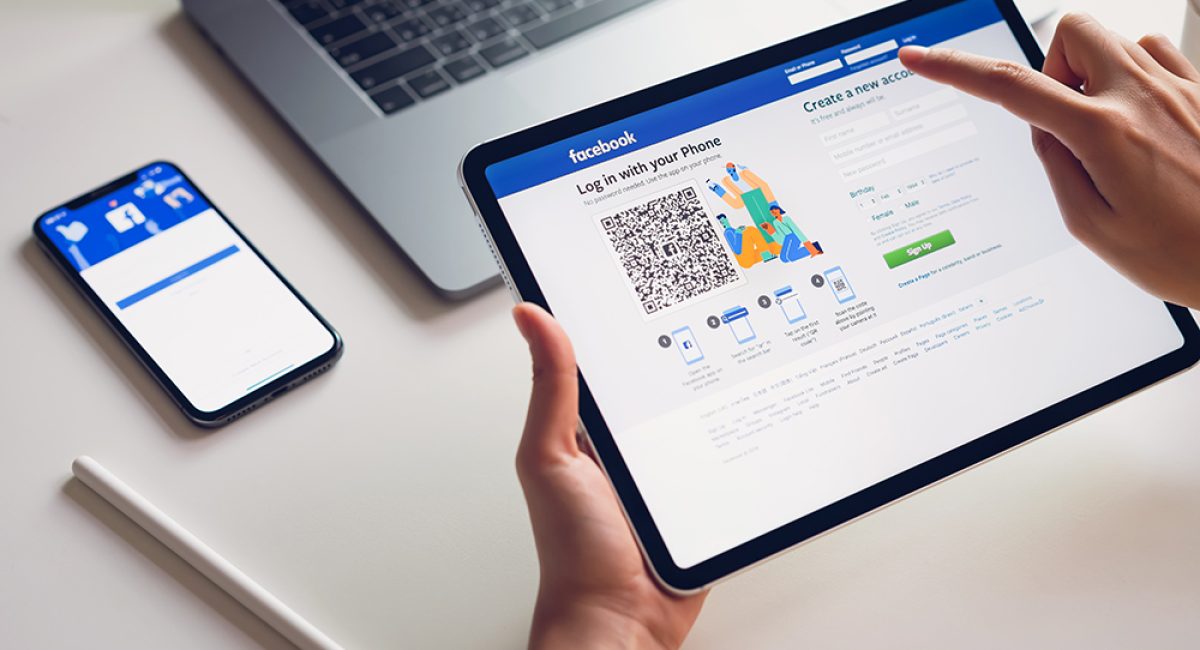 Bangkok, Thailand - February 07, 2019 : hand is pressing the Facebook screen on apple iphone x ,Social media are using for information sharing and networking.