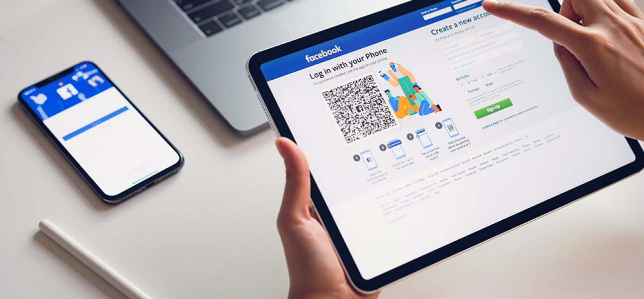 Bangkok, Thailand - February 07, 2019 : hand is pressing the Facebook screen on apple iphone x ,Social media are using for information sharing and networking.