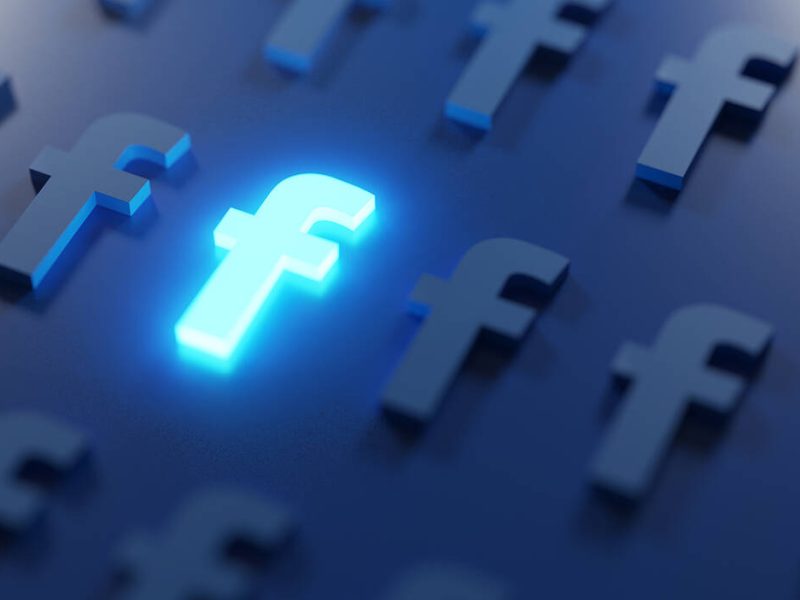 Stand Out on Social Media Concept. Glowing Facebook Logo
